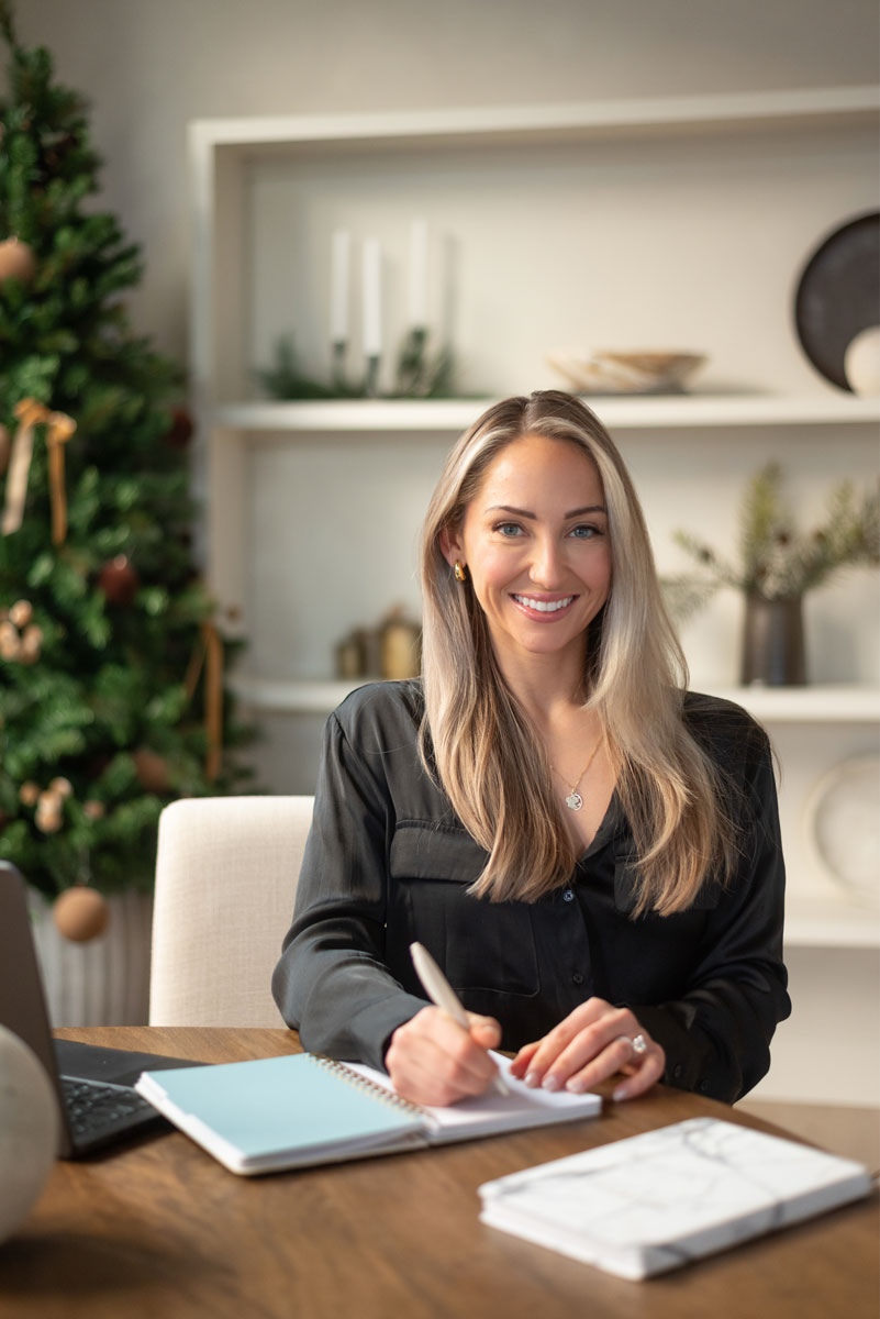 The coach is sitting and about to write someting.